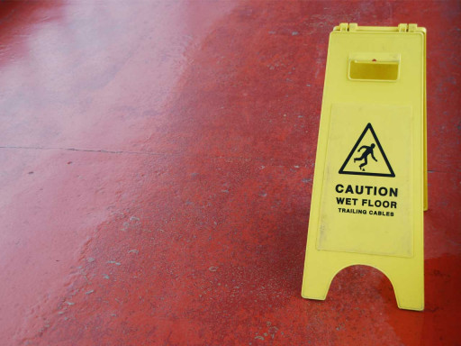 Caution wet floor sign on a red floor.