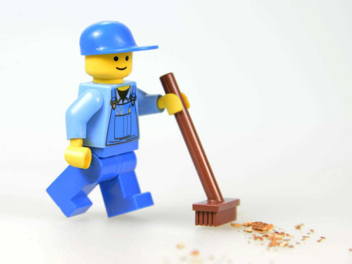 Lego character sweeping the floor.